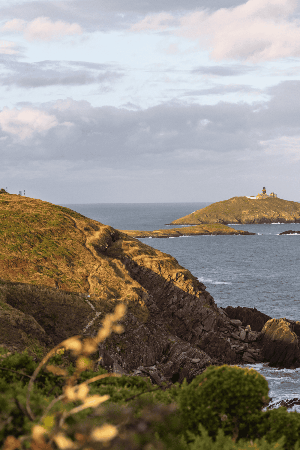 Breathtaking coastal landscape with scenic cliffs and historic lighthouse on the island. Perfect for travel planning and scenic adventures.