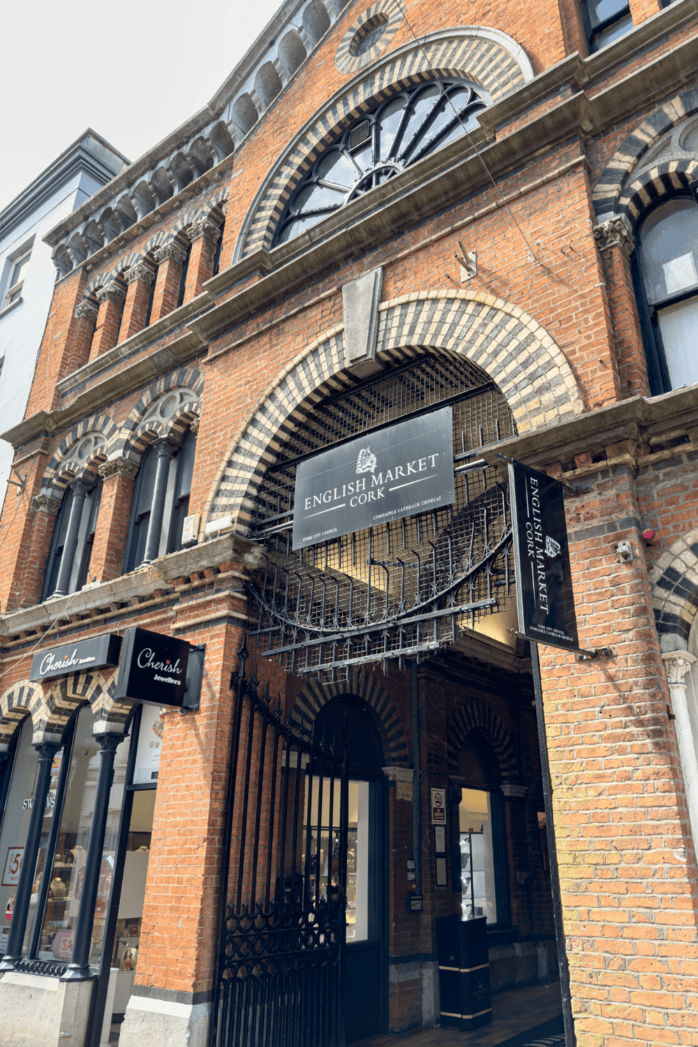 Historic brick building housing English Market Cork with unique architectural details.