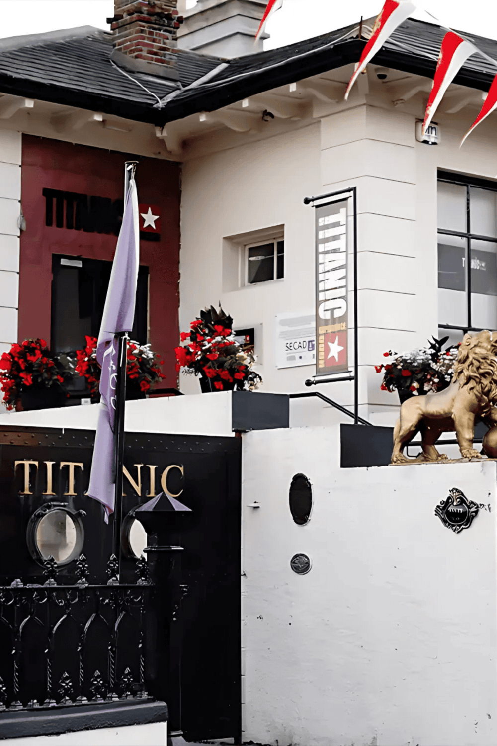 Elegant restaurant exterior with floral decor and lion statue, perfect for dining and nightlife entertainment.
