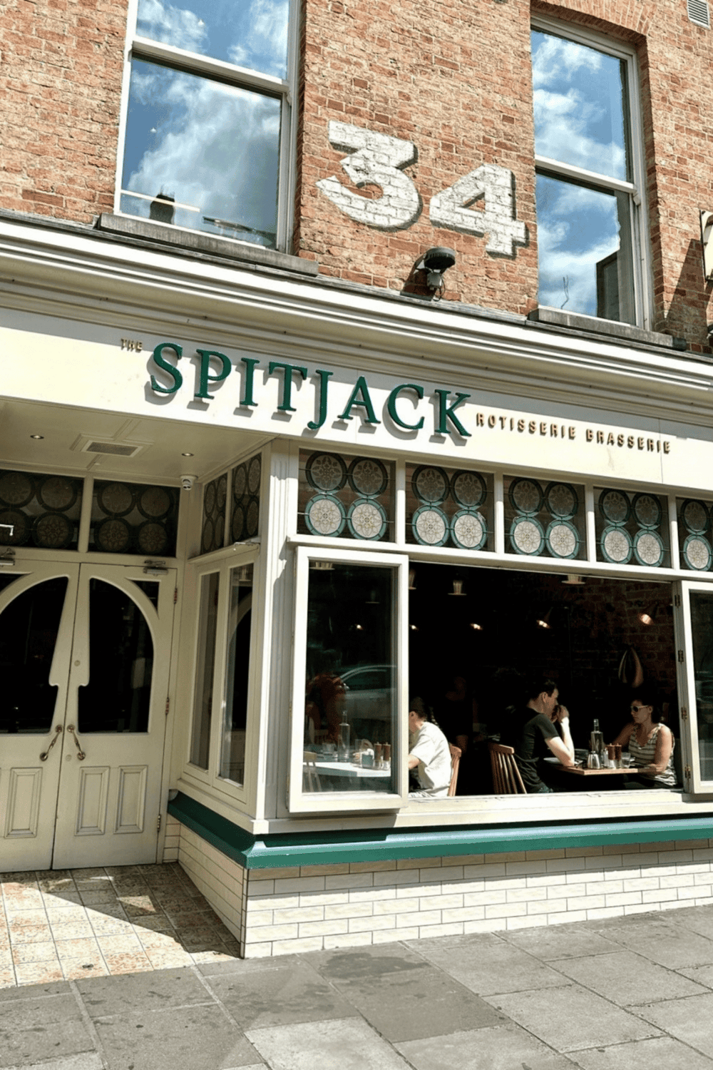 Vintage brick building with restaurant "The Spitjack" exterior view, inviting dine-in atmosphere, and street setting.