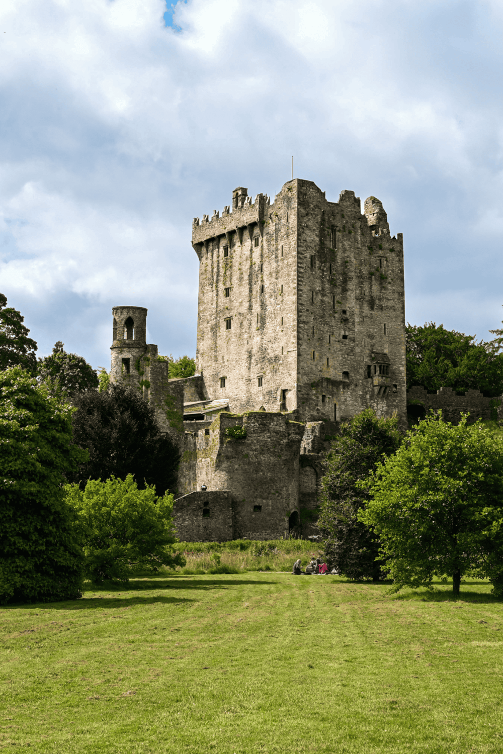Medieval castle in Scotland surrounded by lush greenery and open lawn, iconic historic landmark and tourist attraction.