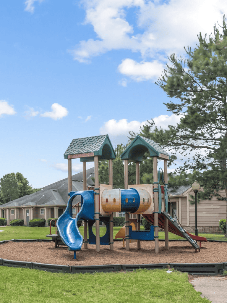 Colorful children’s playground with tunnels and slides at a residential park.