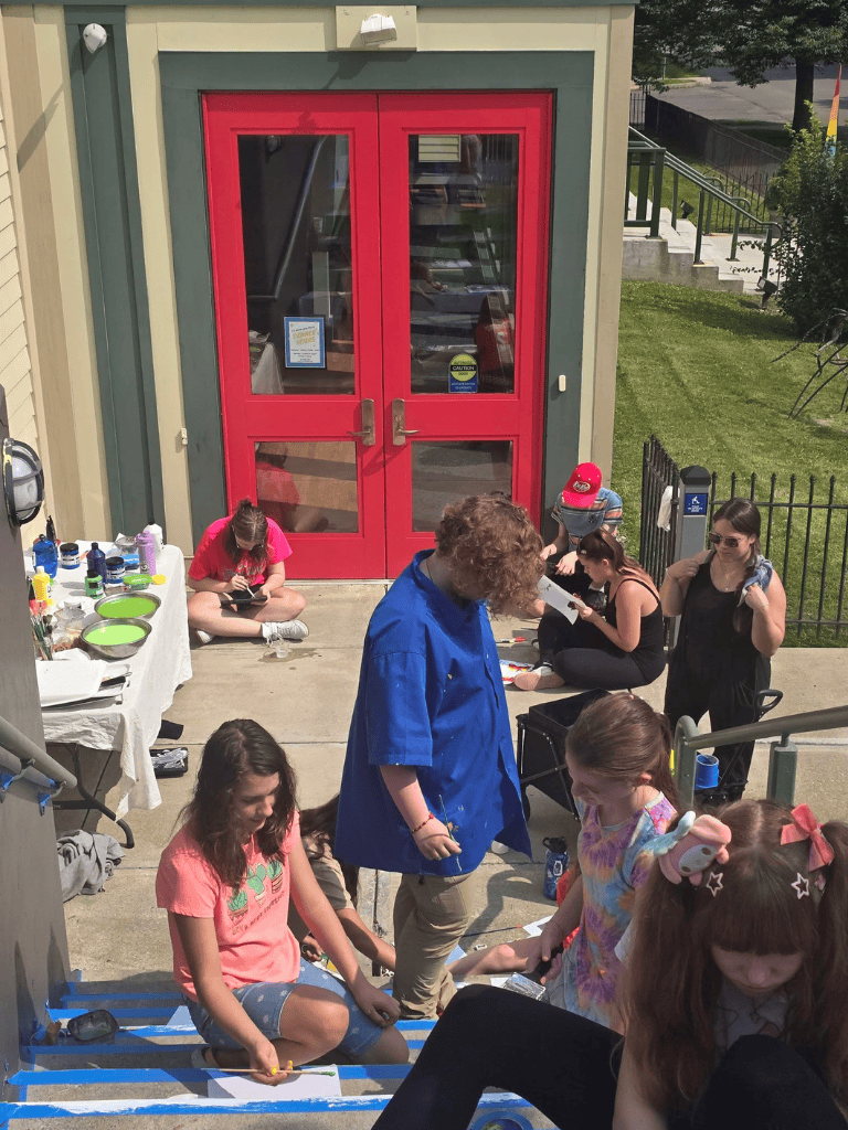 Kids participating in an outdoor arts and crafts event at QuestForDirections.