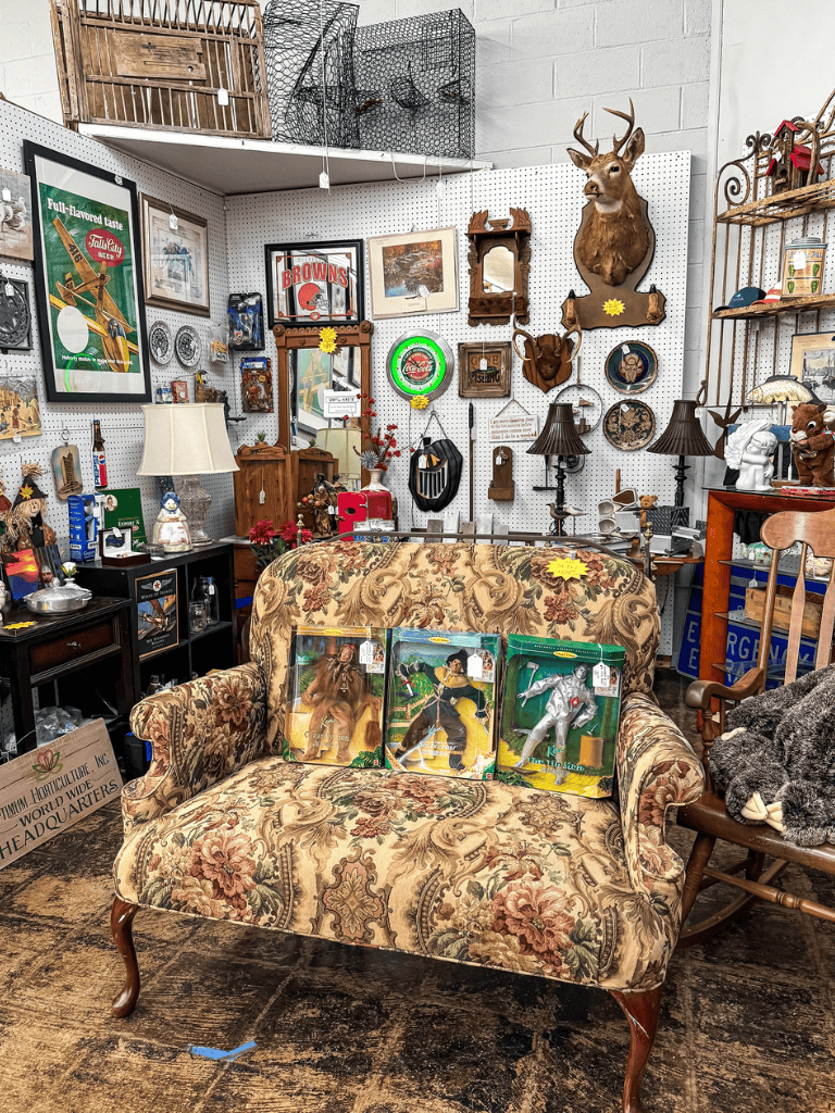 Antique shop interior with vintage decor, figurines, and collectibles for sale.