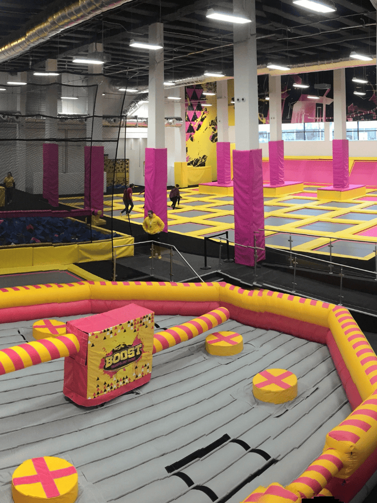 Colorful indoor trampoline park with foam pits and obstacle courses, perfect for family fun and active entertainment.