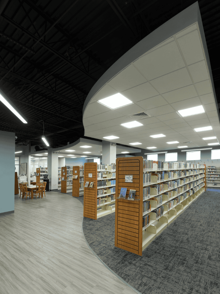 History and reference books in a modern library setting with QuestForDirections signage.