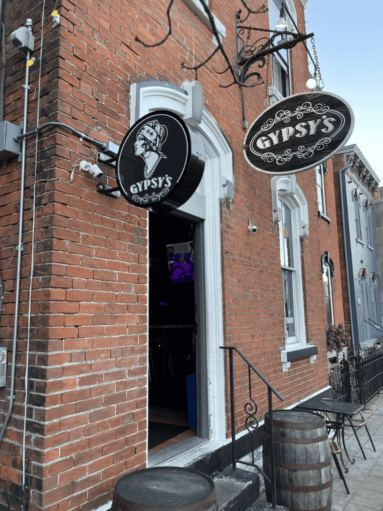Cozy Gypsy's bar with vintage decor in a brick building, inviting for nightlife and live music.