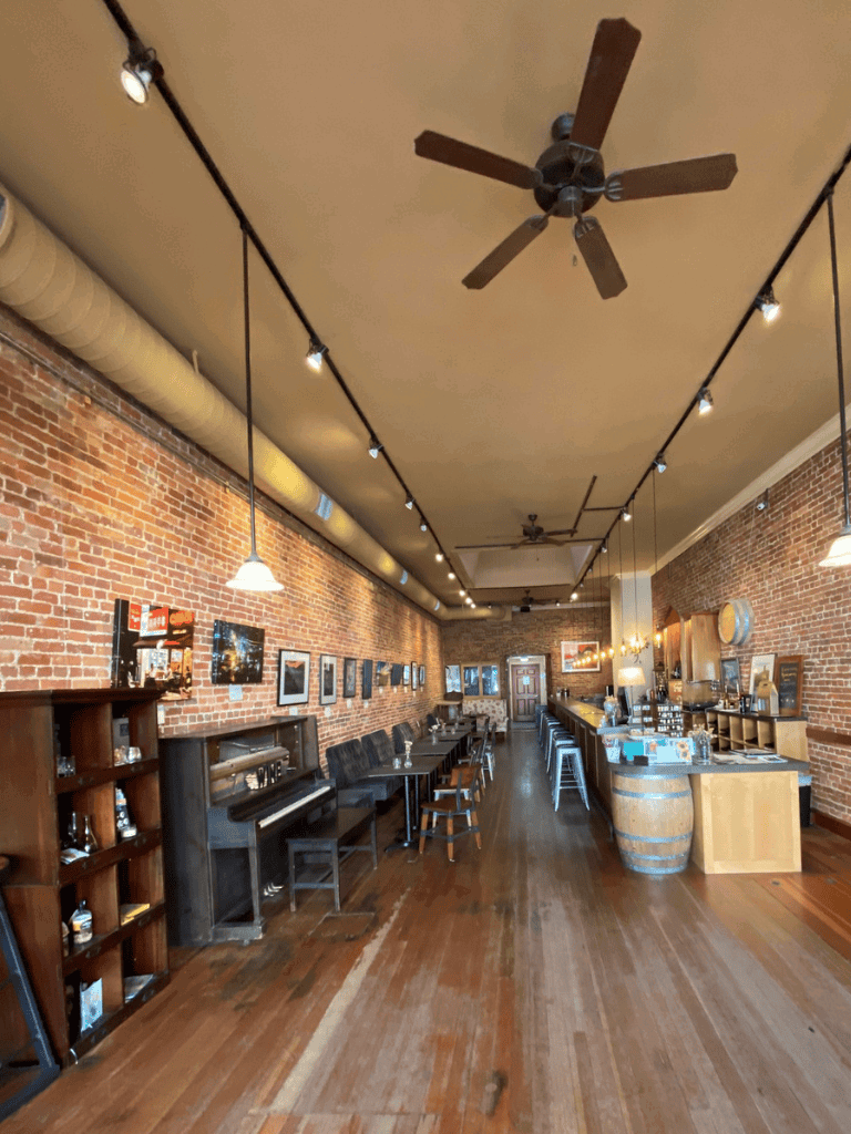 Cozy brick-walled restaurant interior with wooden floors and bar, perfect for dining at QuestForDirections.