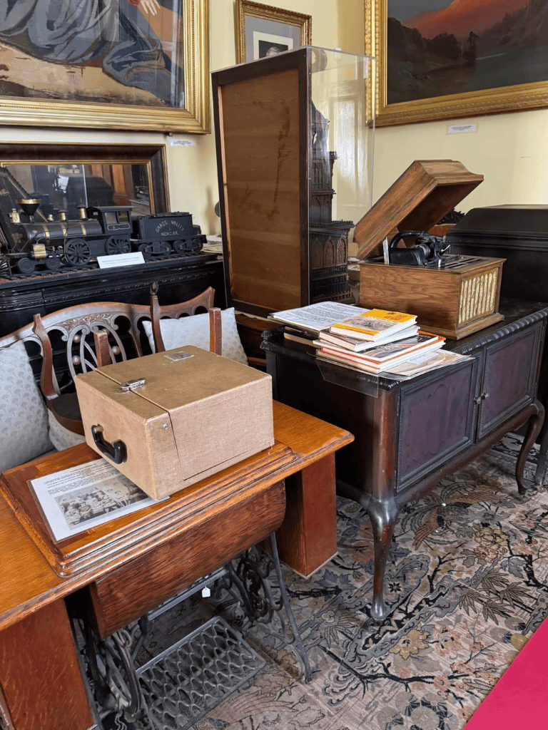 Vintage antique train display with historical artifacts and framed artwork at QuestForDirections.