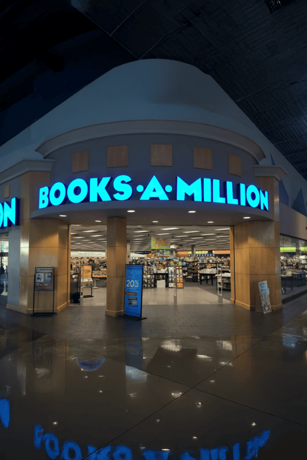 Large bookstore entrance with bright blue sign reading "BOOKS A MILLION" in a shopping mall.