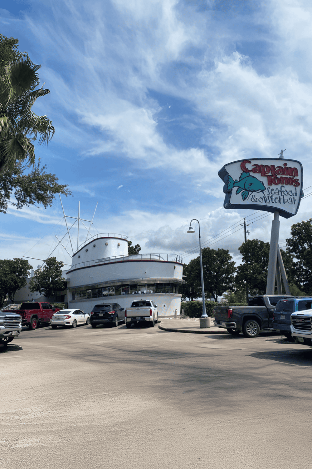 Boat-themed seafood restaurant in a sunny coastal setting with parking.