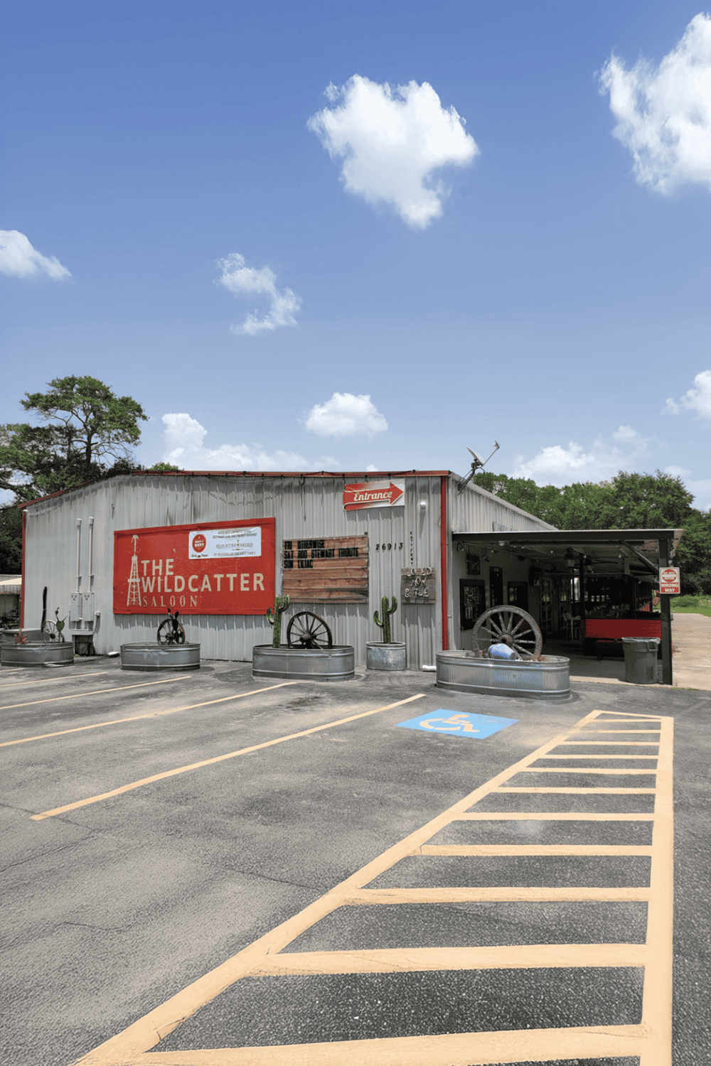 Rustic saloon named The Wild Catter Saloon with country decor, parking, and handicap accessible space.