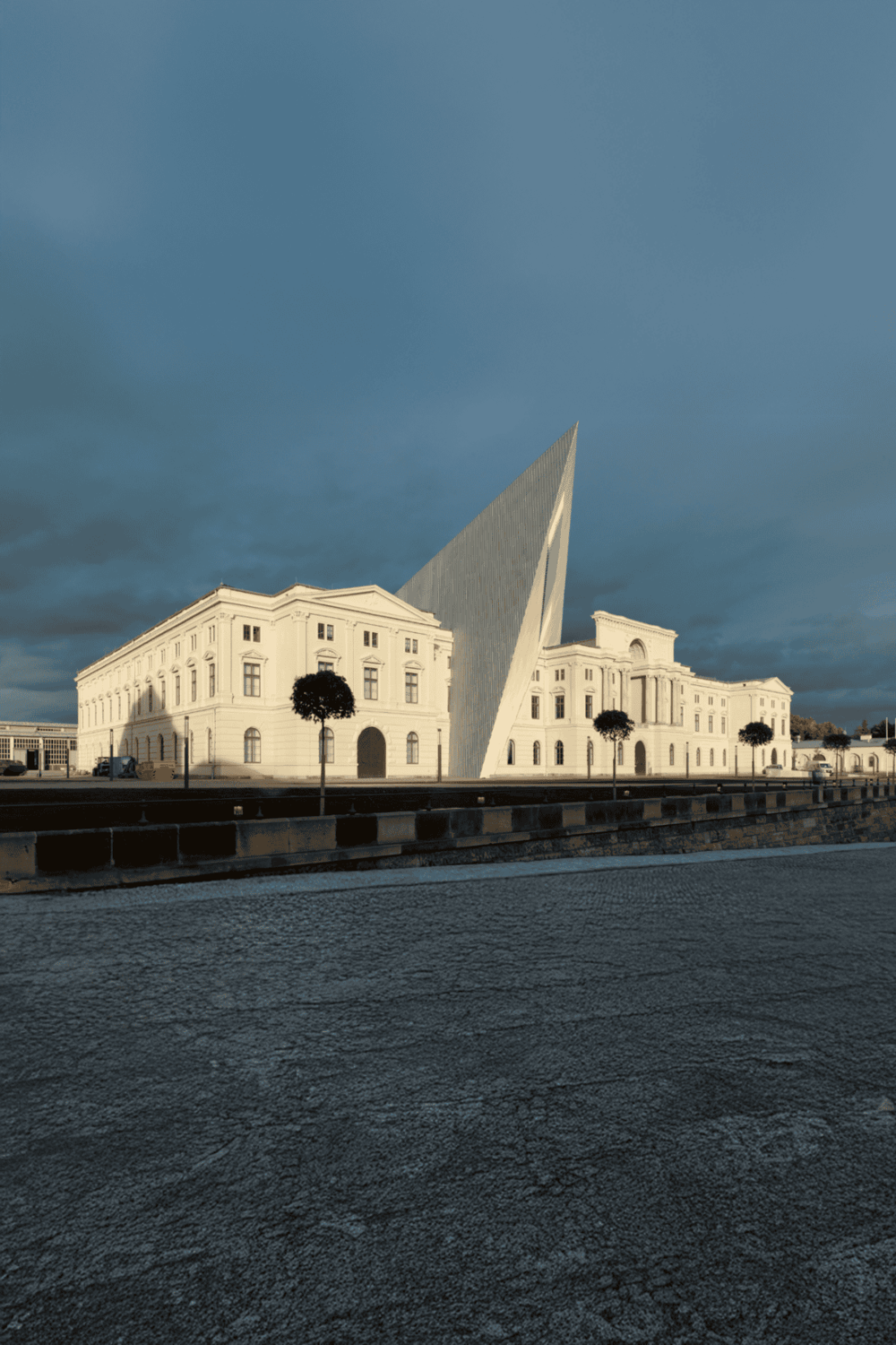 Modern architecture building with unique angular design and historic surrounding, showcasing innovative urban design.