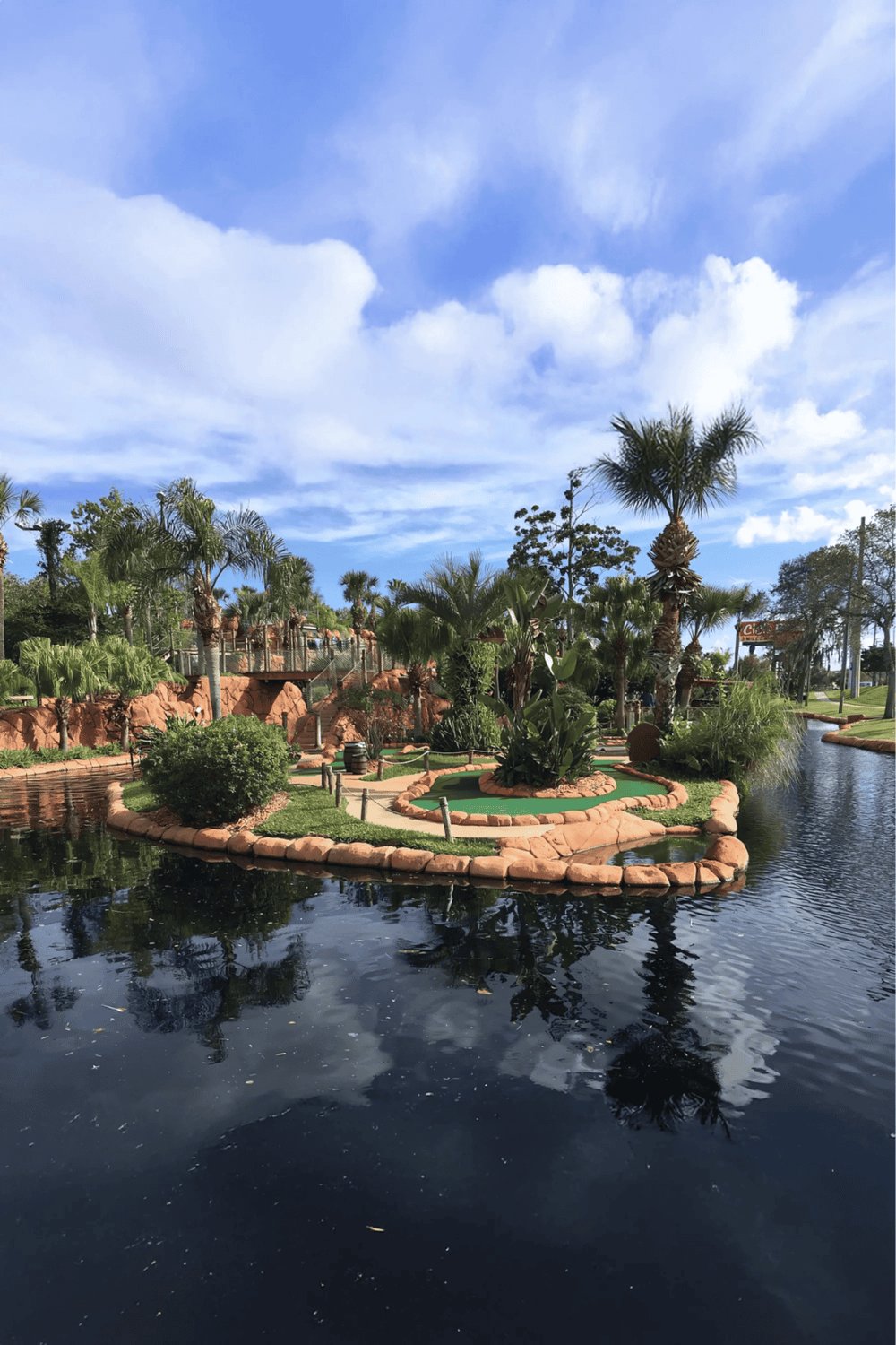 1. Serene tropical landscape with palm trees and water feature at QuestForDirections.