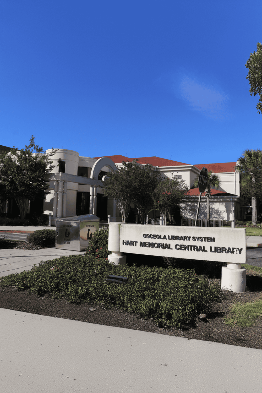 Osceola Library System Hart Memorial Central Library, Florida, with bright blue sky.
