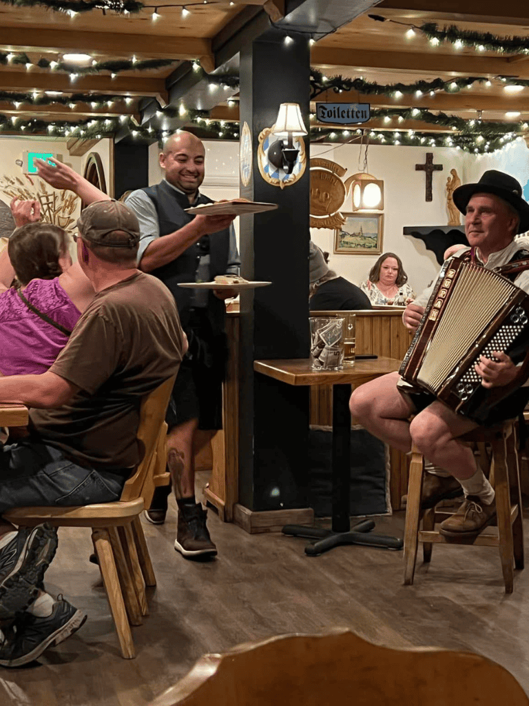 Comfortable restaurant with live music, cozy Christmas decor, and friendly staff serving delicious food. Perfect for a festive night out.