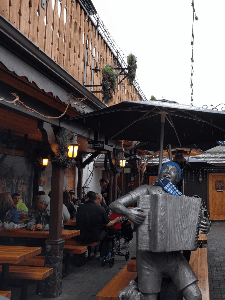 Enjoy dining at QuestForDirections with lively atmosphere and unique street performer statue outside.