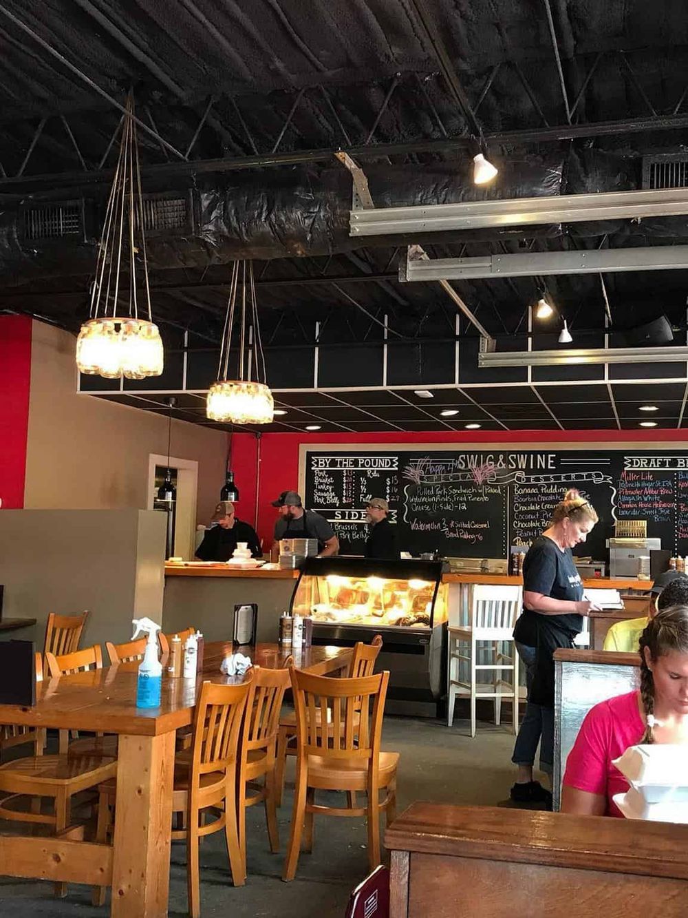 Cozy restaurant interior with customers and staff, inviting atmosphere for dining and socializing.