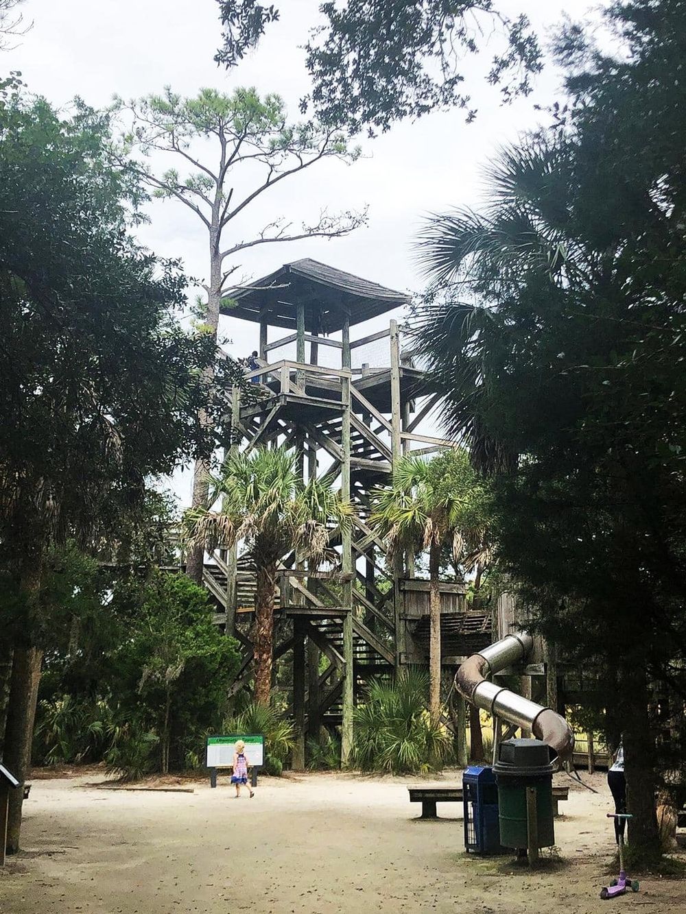 A wooden observation tower amid lush greenery, offering scenic views and outdoor adventure.