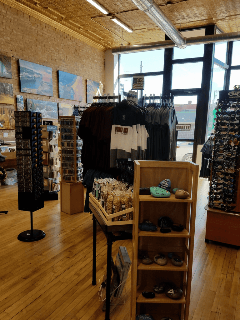 Comfy retail store interior with clothing, accessories, and artwork displays.