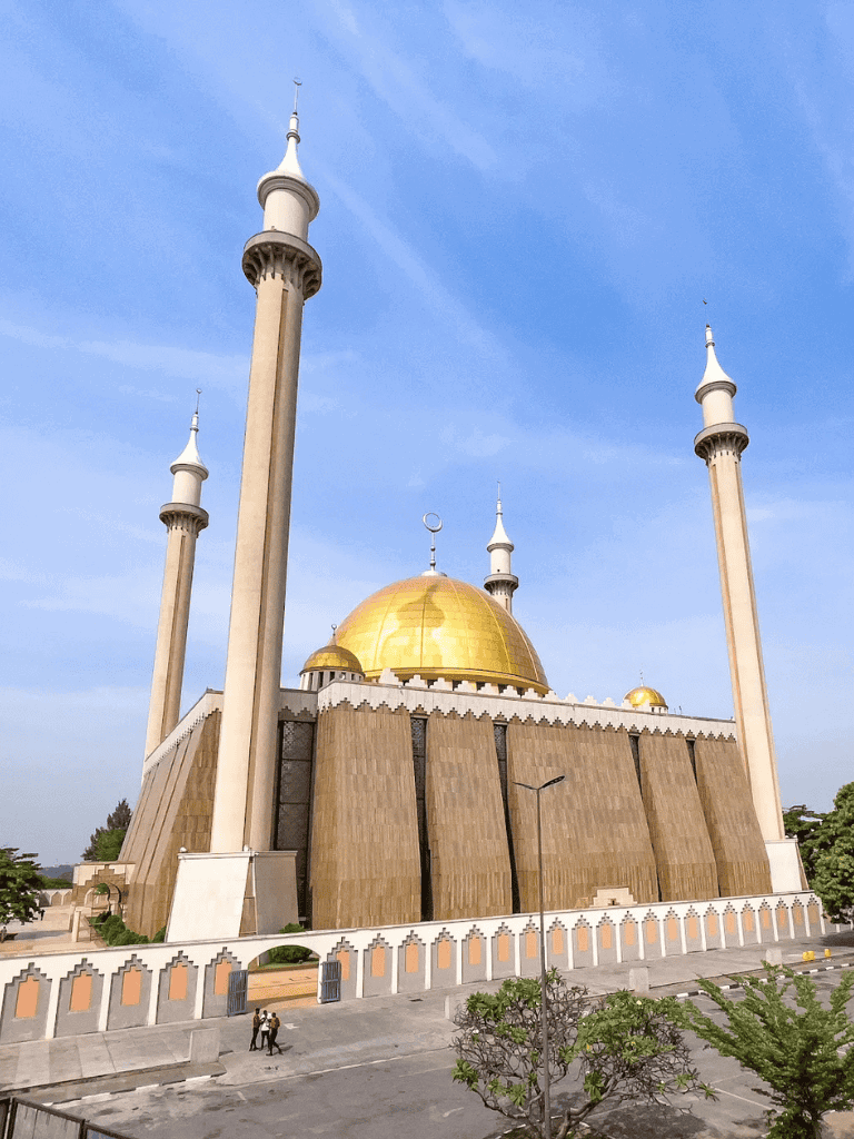 Elegant mosque with golden dome and towering minarets, iconic landmark for travel and religious visits.