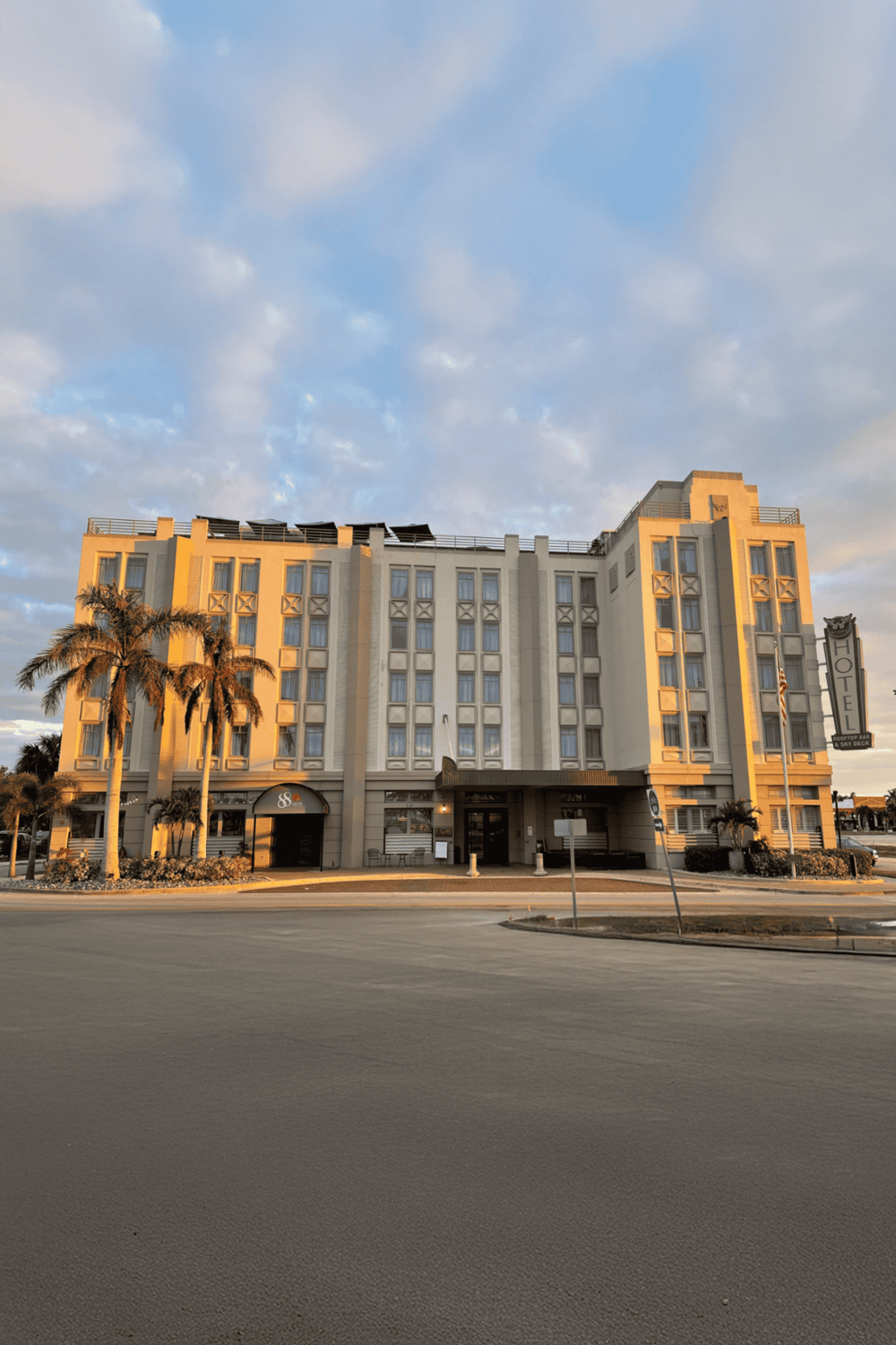 Comfortable hotel with palm trees and retro architecture, ideal for travelers seeking Downtown West Palm Beach stays.