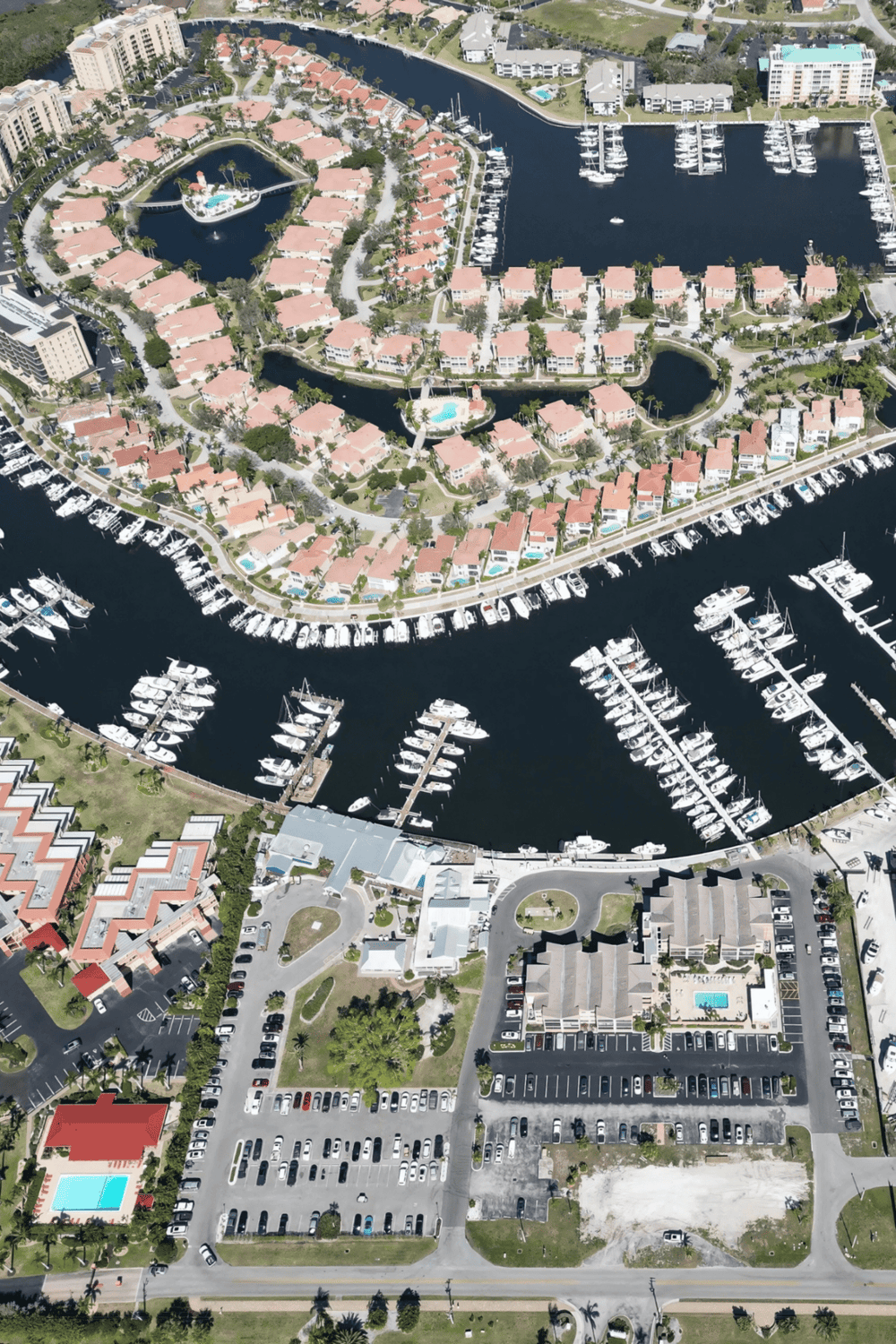 Upscale waterfront residential community with boat docks and lush landscaping.