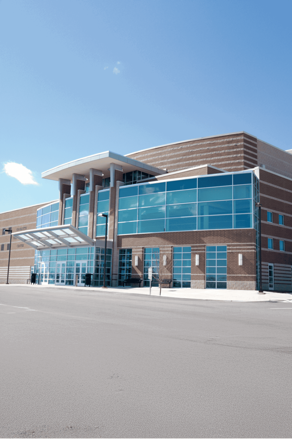 Modern medical center with glass facade and brick exterior, located in a professional healthcare setting.