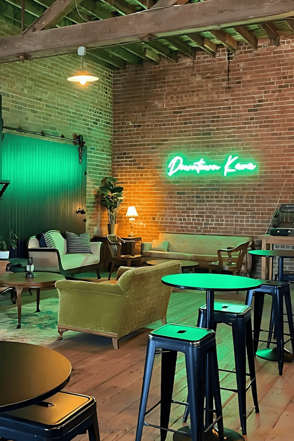 Cozy downtown cafe with neon sign and stylish seating perfect for socializing and relaxing.