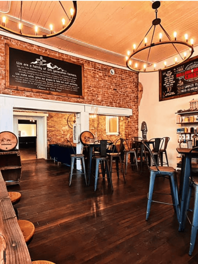 Charming interior of a cozy coffee shop with brick walls, wooden furniture, and warm lighting.
