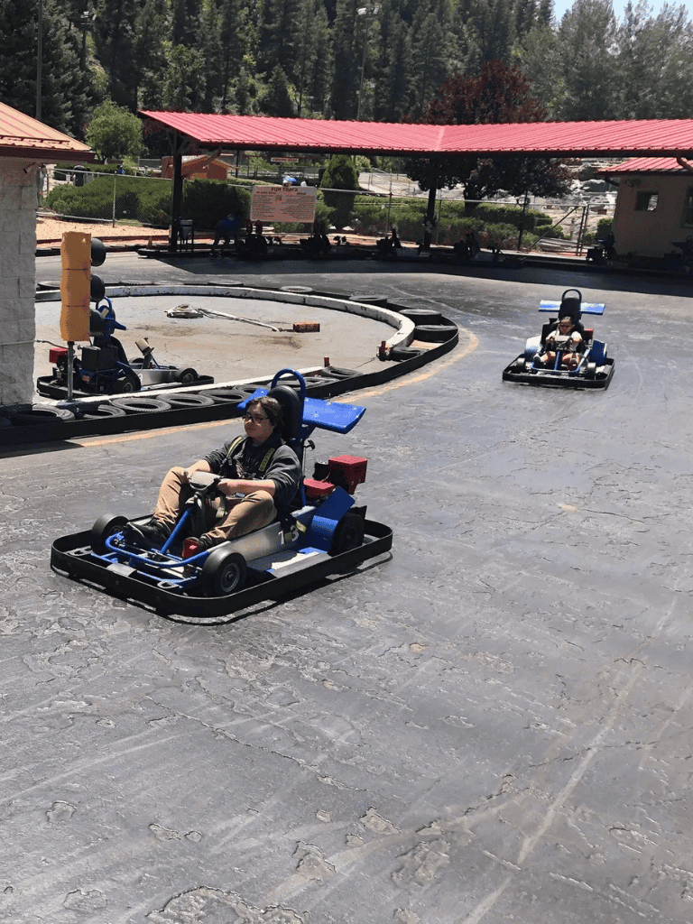 Kids go-kart racing at QuestForDirections, fun indoor activity for children.