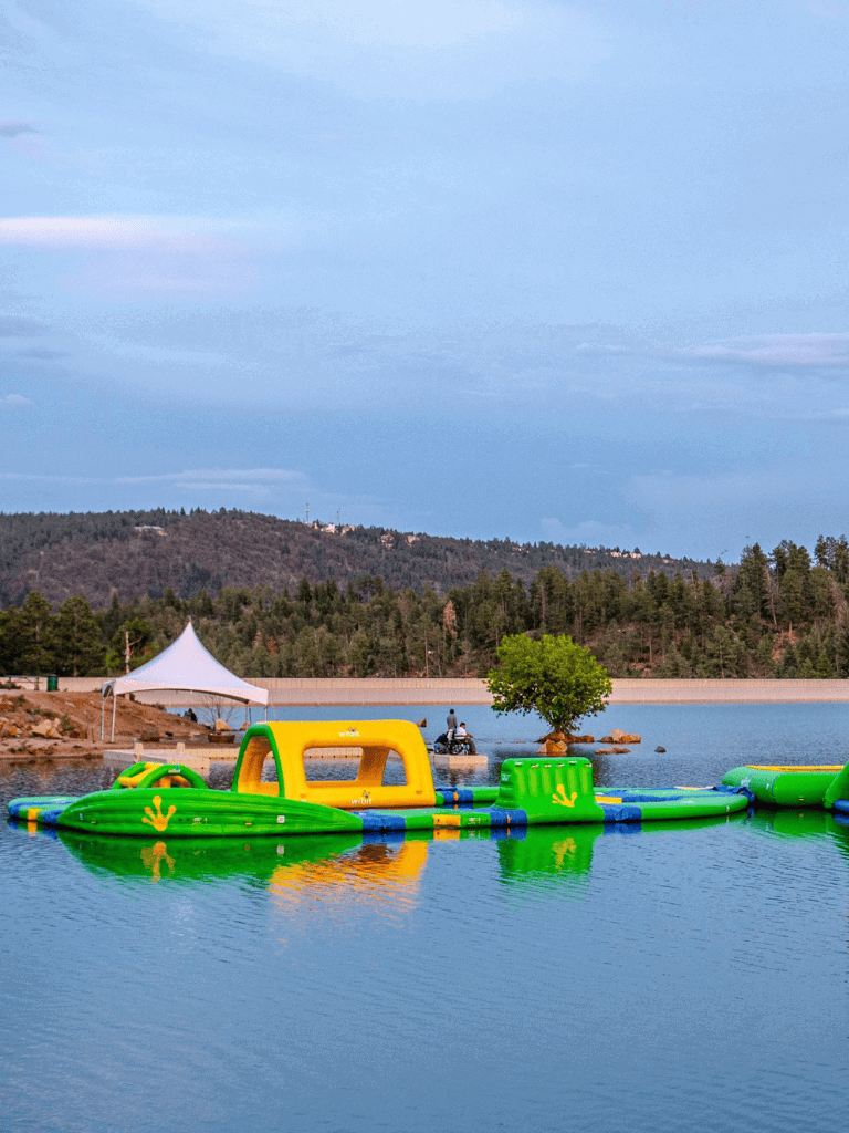 Inflatable water obstacle course on a lake for fun and outdoor adventure activities.