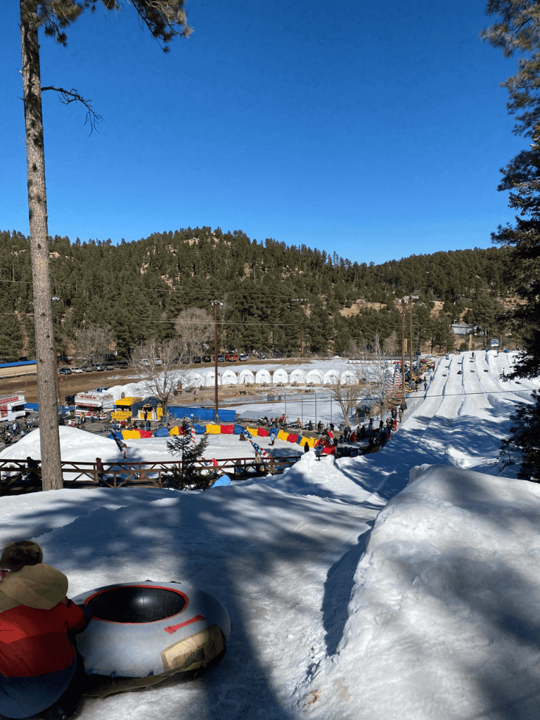 Ski resort with snow tubing and winter activities in a scenic mountain setting.