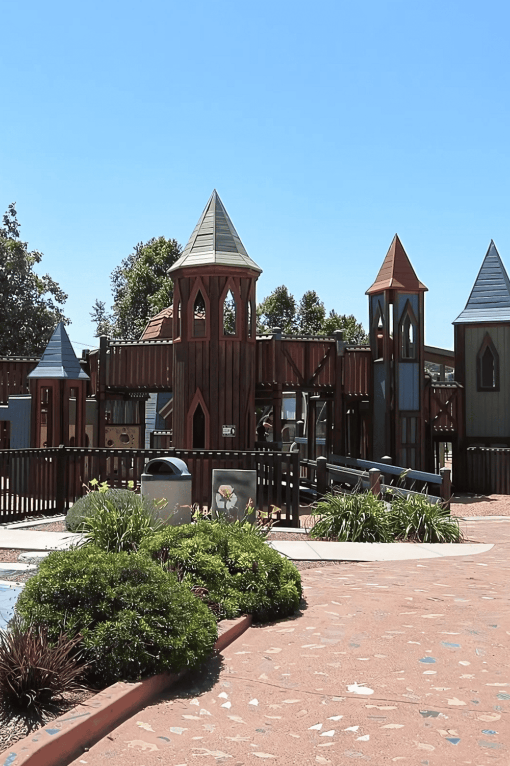 Colorful playground castle with towers and slides for children.
