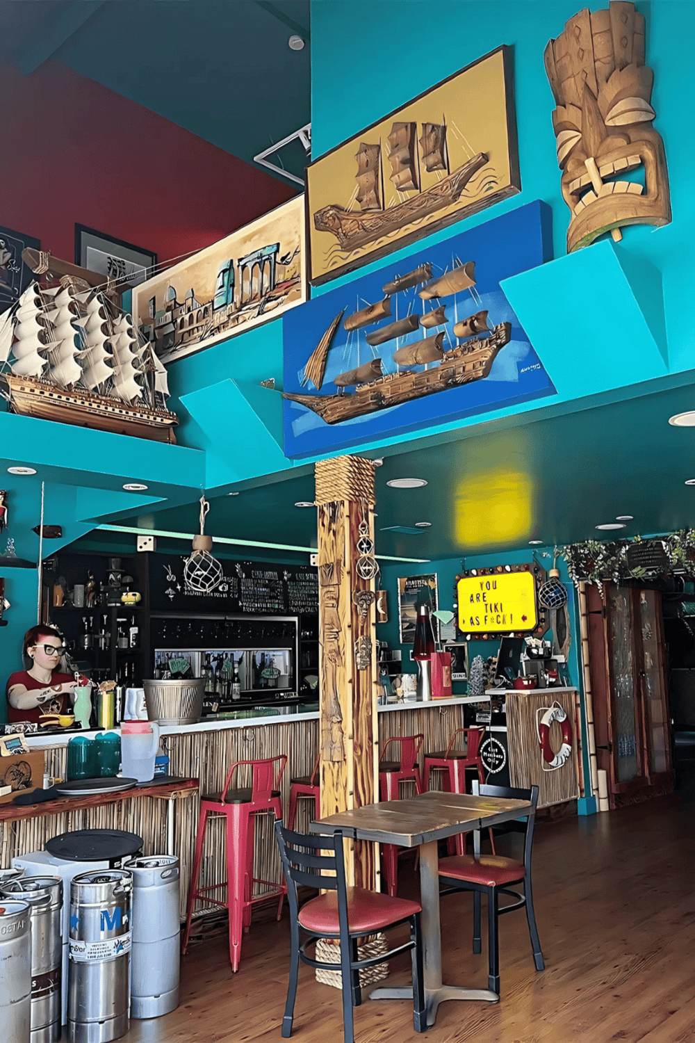 Colorful Polynesian-inspired restaurant interior with nautical décor and wall art.
