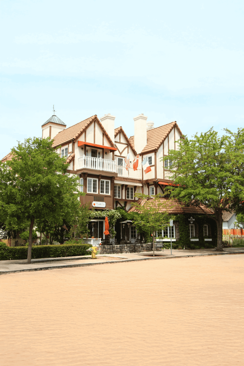 Charming boutique hotel with Tudor-style architecture and lush greenery, perfect for visitors seeking scenic accommodations.