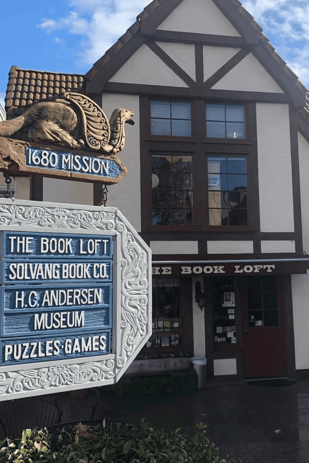 Vintage bookstore and museum entrance in a charming Tudor-style building.