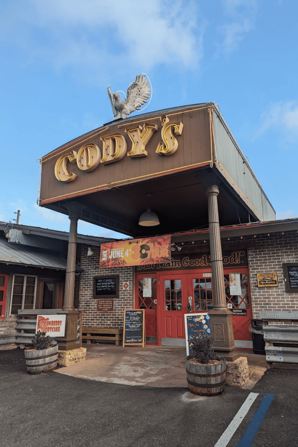 Cozy restaurant with vintage signage and outdoor decor, perfect for American comfort food dining.