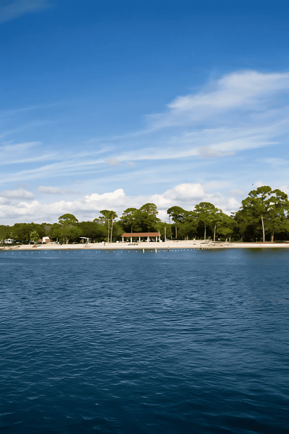 Serene lakeside park for outdoor recreation and relaxation with lush trees and calm water.