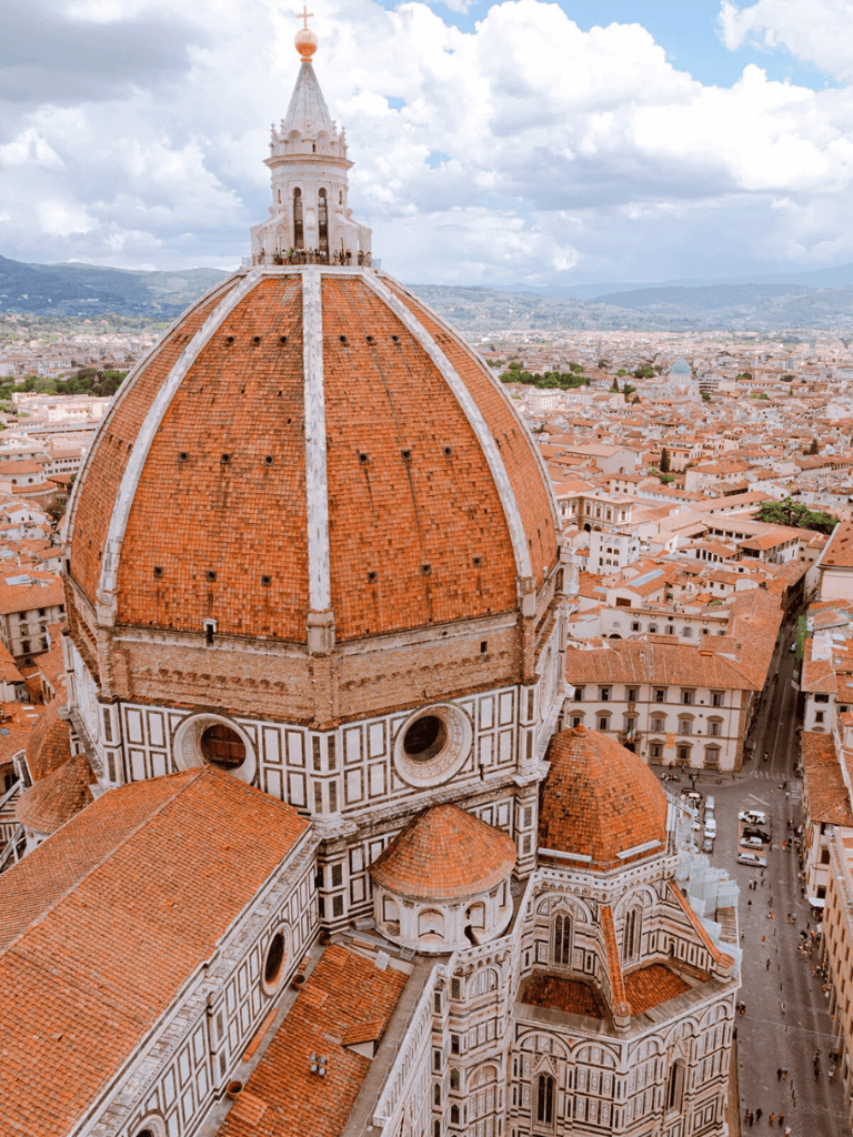 Majestic cathedral dome overlooking Florence skyline with historic architecture.