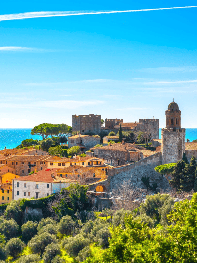 Ancient castle and colorful village along the Mediterranean coast, highlighting scenic coastal views.