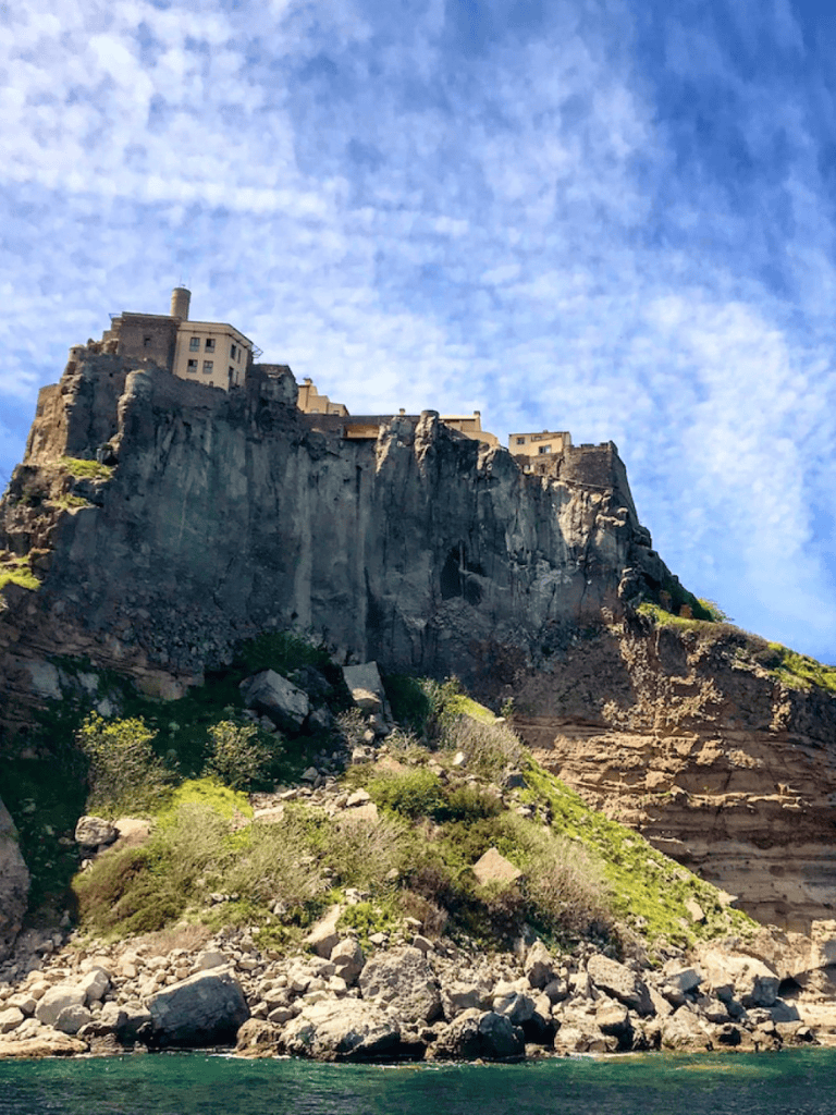 Cliffside San Francisco cityscape with historic buildings on steep rock formation in California.