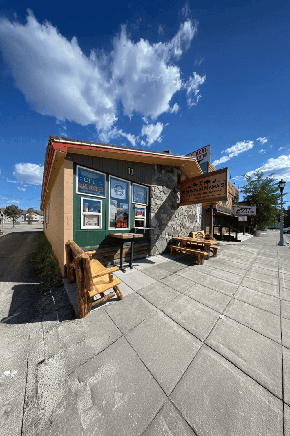 1. Cozy mountain café with outdoor seating and rustic decor, located on a picturesque street.