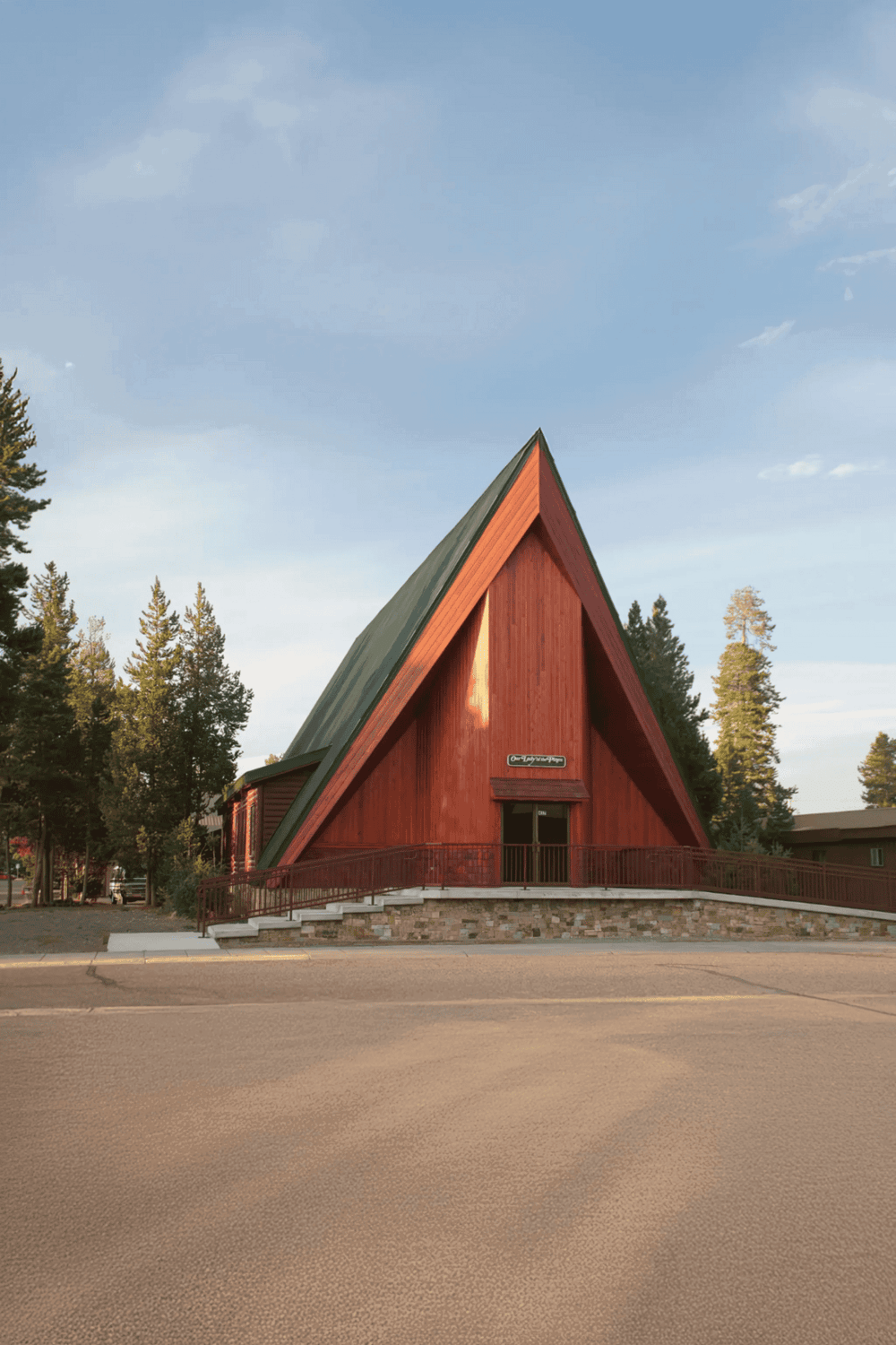 A-frame building in Forest, Oregon, with QuestForDirections signage, surrounded by trees.