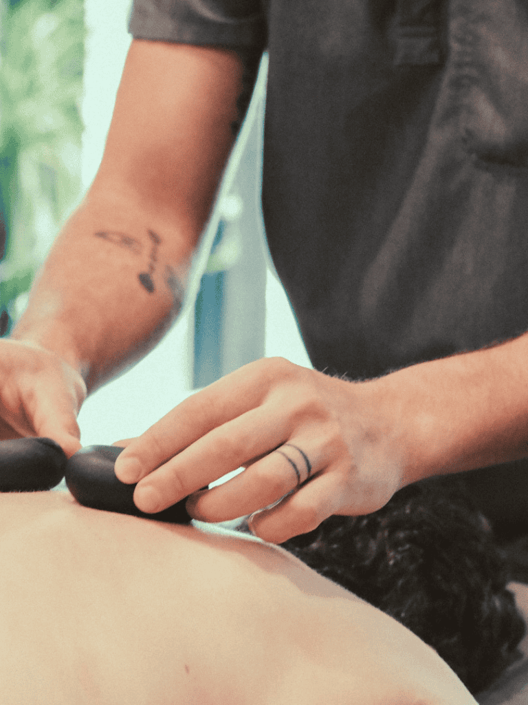 Pain management therapy session with a healthcare professional using a TENS unit.