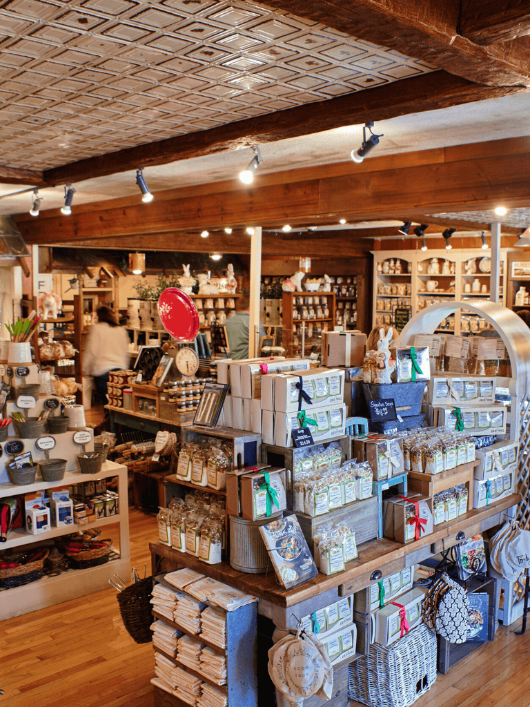 Softly lit interior of a charming shop selling artisanal goods and gifts at Quest For Directions.
