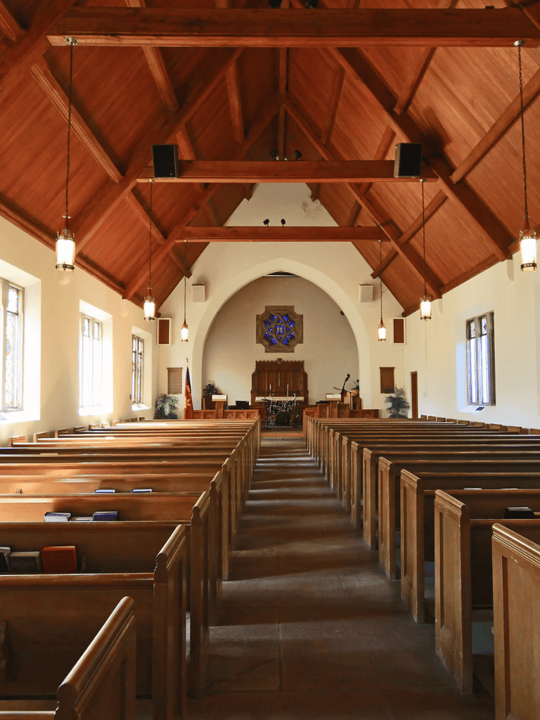 Serene church interior with wooden pews and vaulted ceiling, ideal for worship and community gatherings.