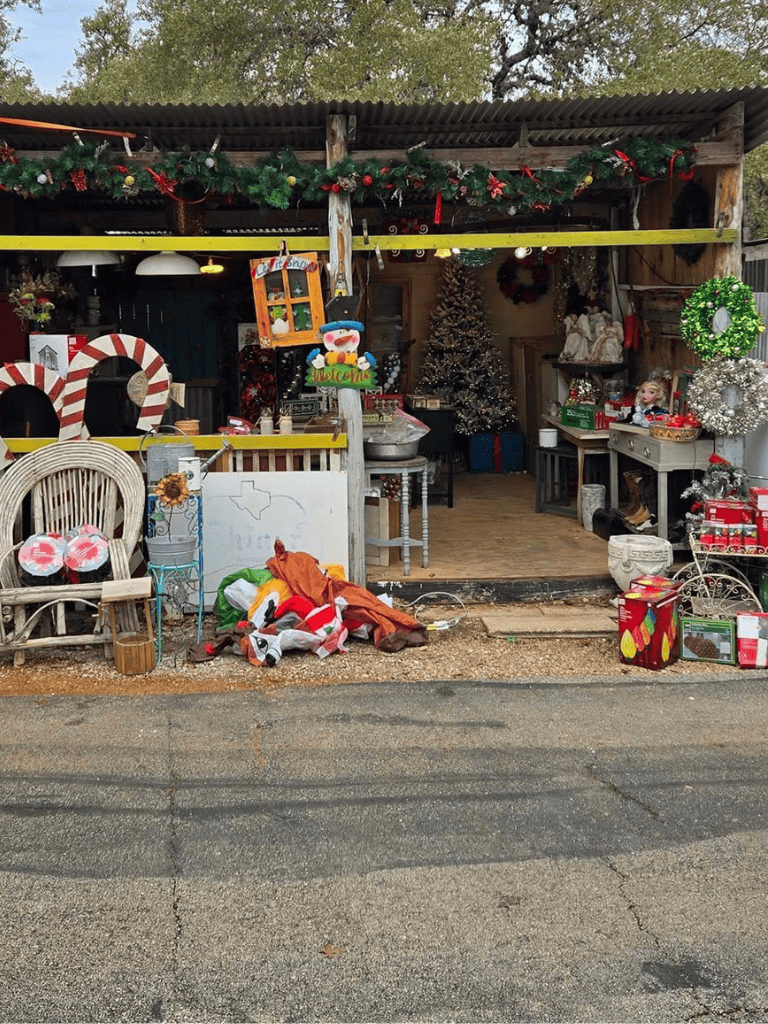 Christmas decorations and holiday bargains at a seasonal outdoor shop.