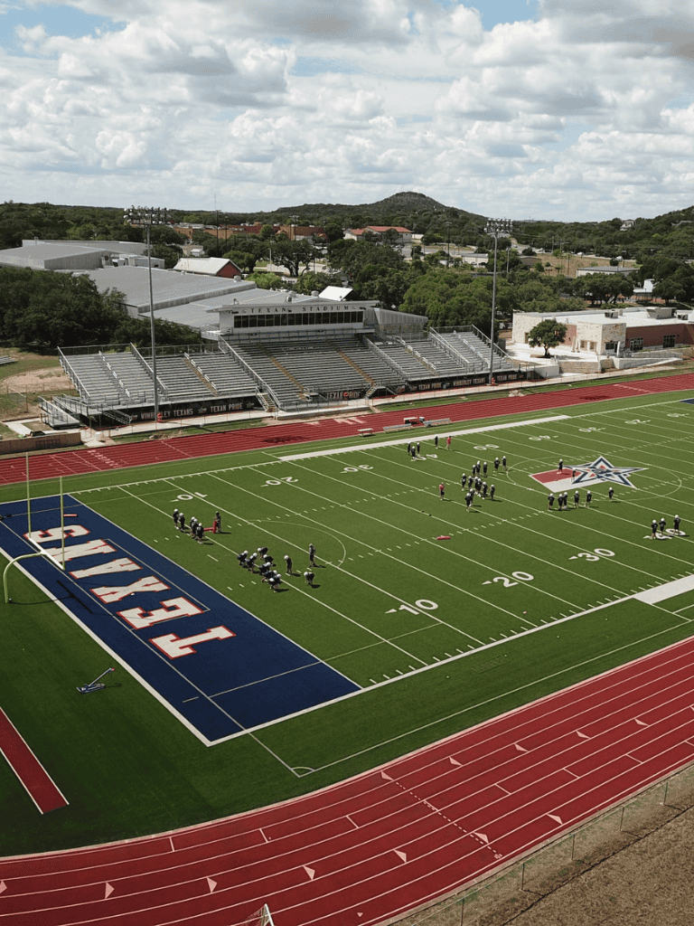 Bright Day at Texan Stadium with Football Players Practice.