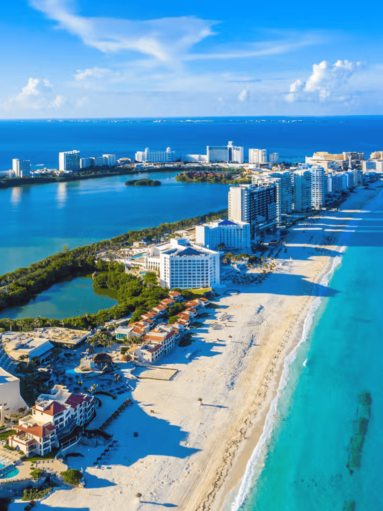 Aerial view of Miami Beach with high-rise hotels, sandy beaches, and turquoise ocean waters.